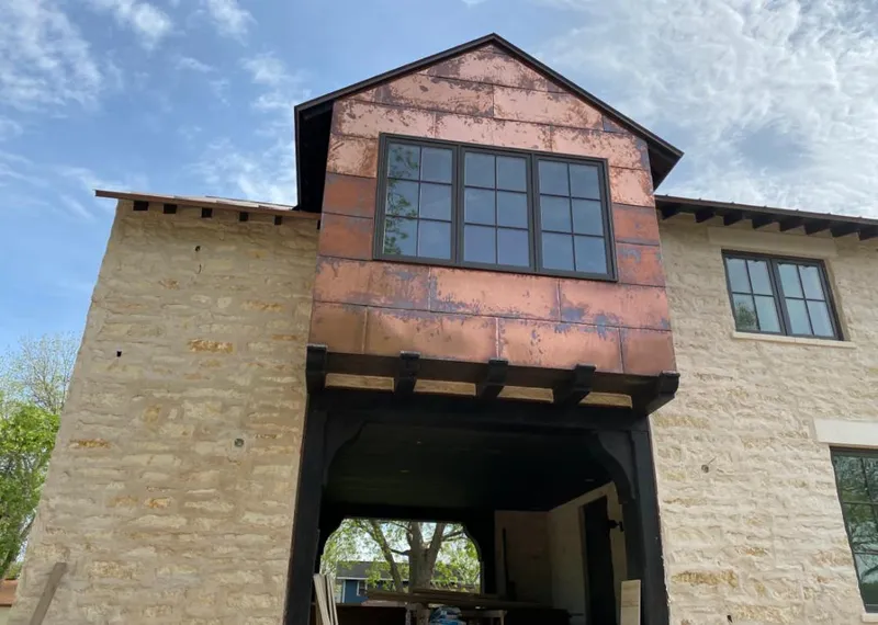 Copper metal panel facade on a stone building for Skylight Installation in Ruidoso